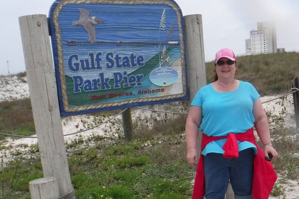 A Woman Posing by the Gulf State Park Pier