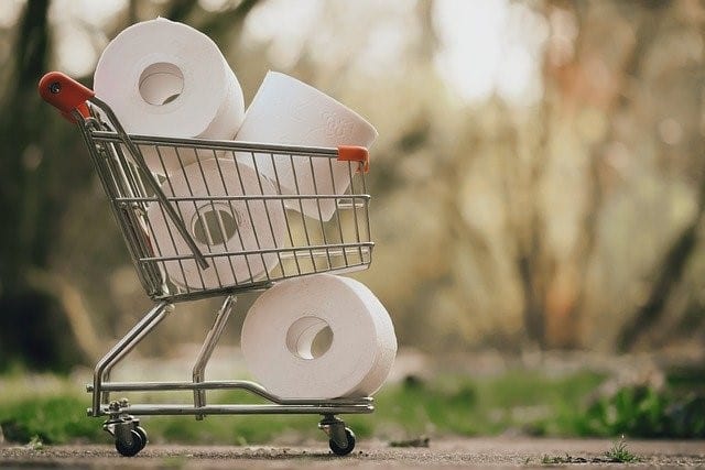 A Shopping Cart With Tissue Rolls